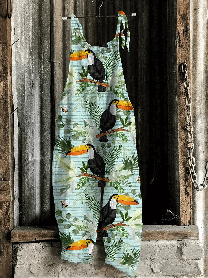 Lightweight artisanal jumpsuit in sky blue with toucan & jungle leaf print