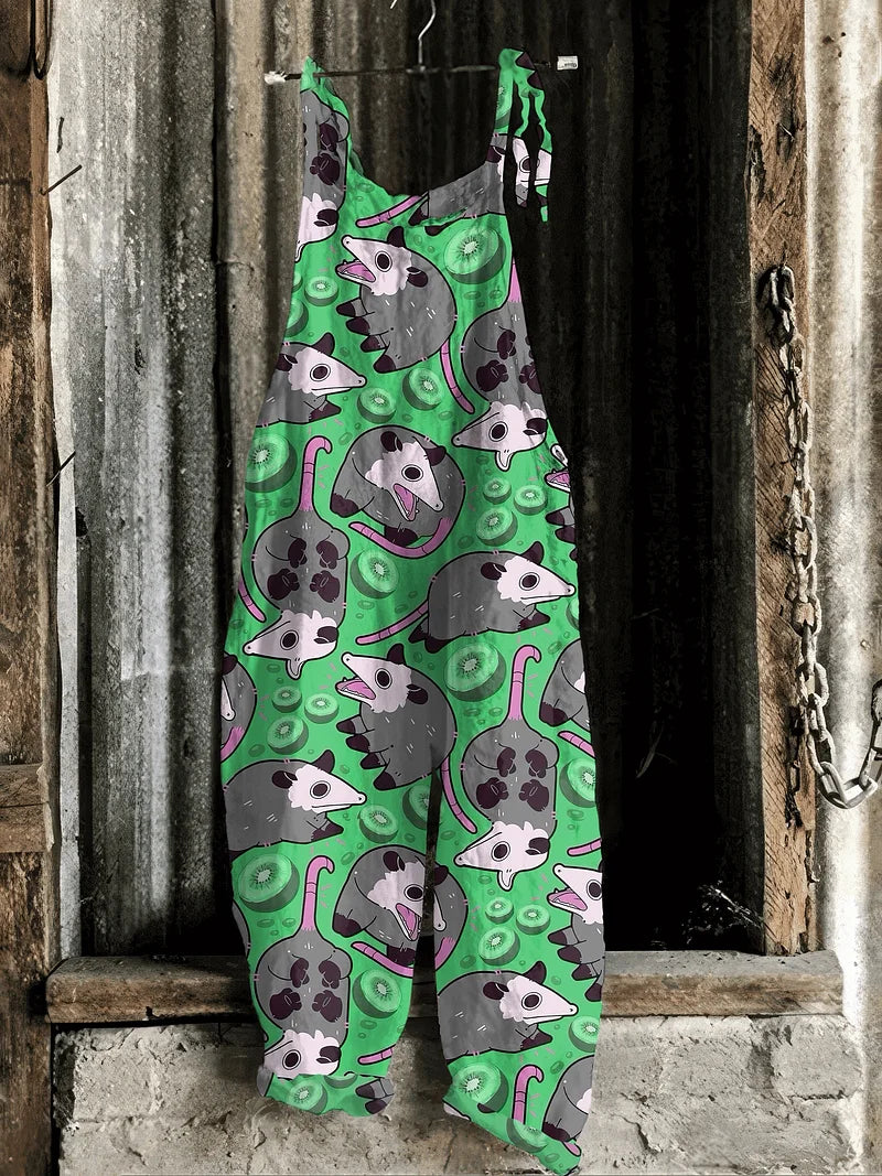 Lightweight artisanal jumpsuit in green cartoon possum & kiwi print