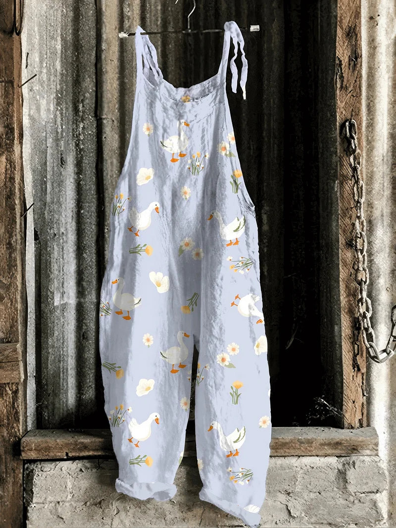 Lightweight artisanal jumpsuit in soft blue with goose & wildflower print